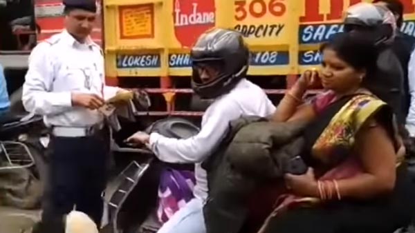 ദേ ഇത്രയേയുള്ളൂ സുരക്ഷ, സ്കൂട്ടര് യാത്രികയുടെ ഹെല്മറ്റ് എറിഞ്ഞുടച്ച് പൊലീസ് — വീഡിയോ