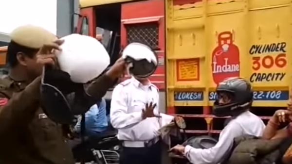 ദേ ഇത്രയേയുള്ളൂ സുരക്ഷ, സ്കൂട്ടര് യാത്രികയുടെ ഹെല്മറ്റ് എറിഞ്ഞുടച്ച് പൊലീസ് — വീഡിയോ